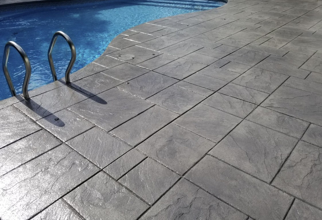 Beautiful stamped concrete pool deck installation by Colton concrete contractors